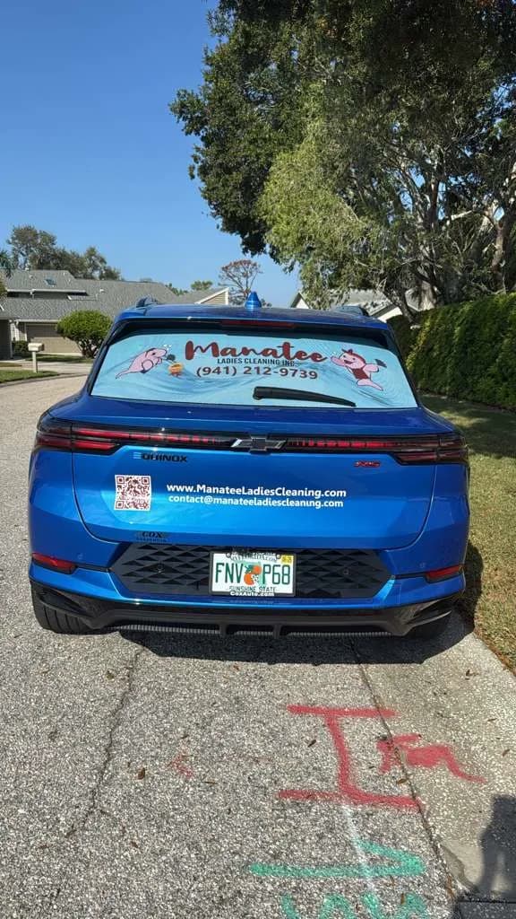 The Manatee Ladies Cleaning vehicle with the company phone number, parked at a Bradenton home