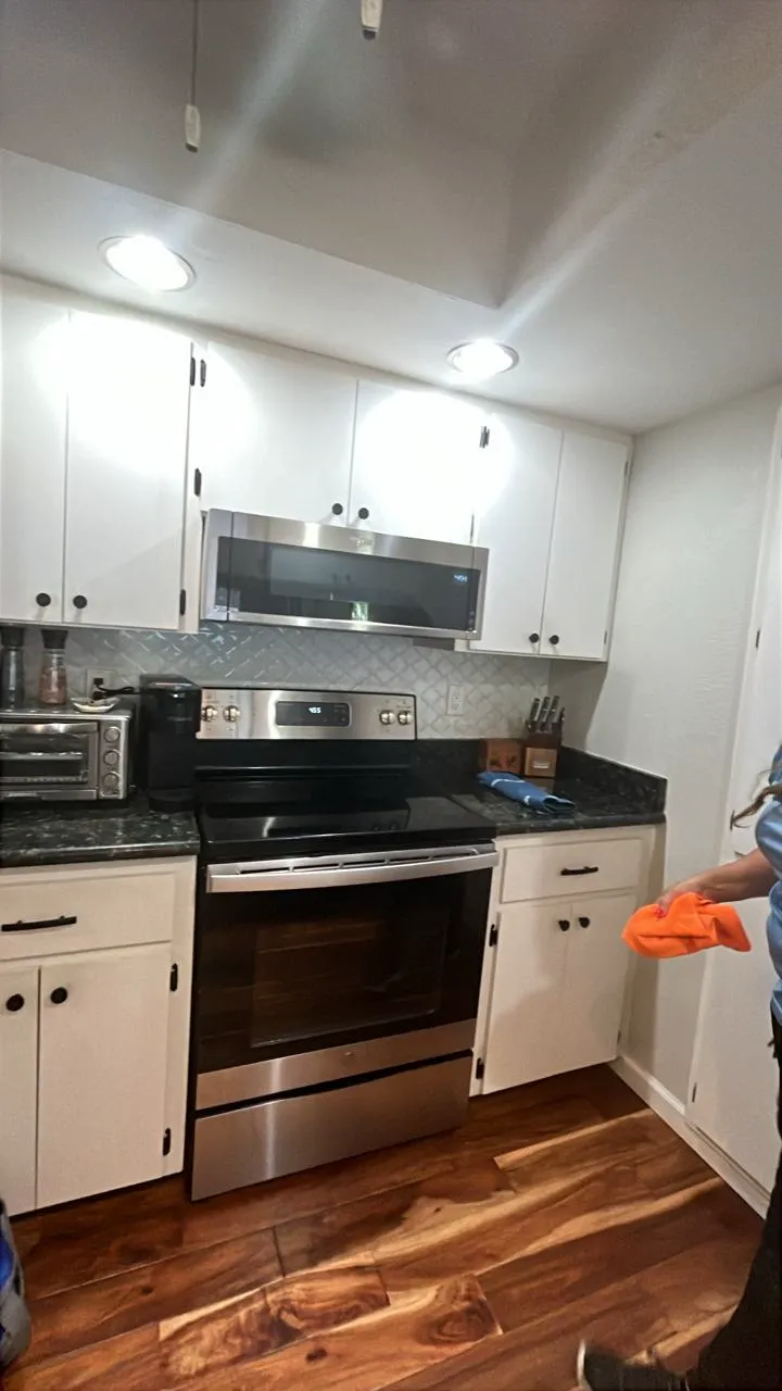 A spotless modern kitchen with stainless appliances and granite counters after a Manatee Ladies clean