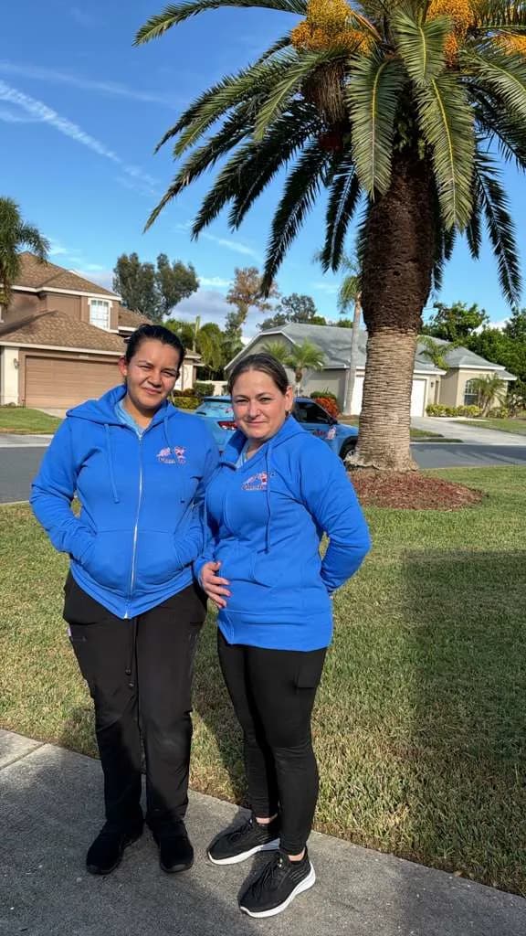 Two Manatee Ladies crew members outside a client home in Bradenton, Florida
