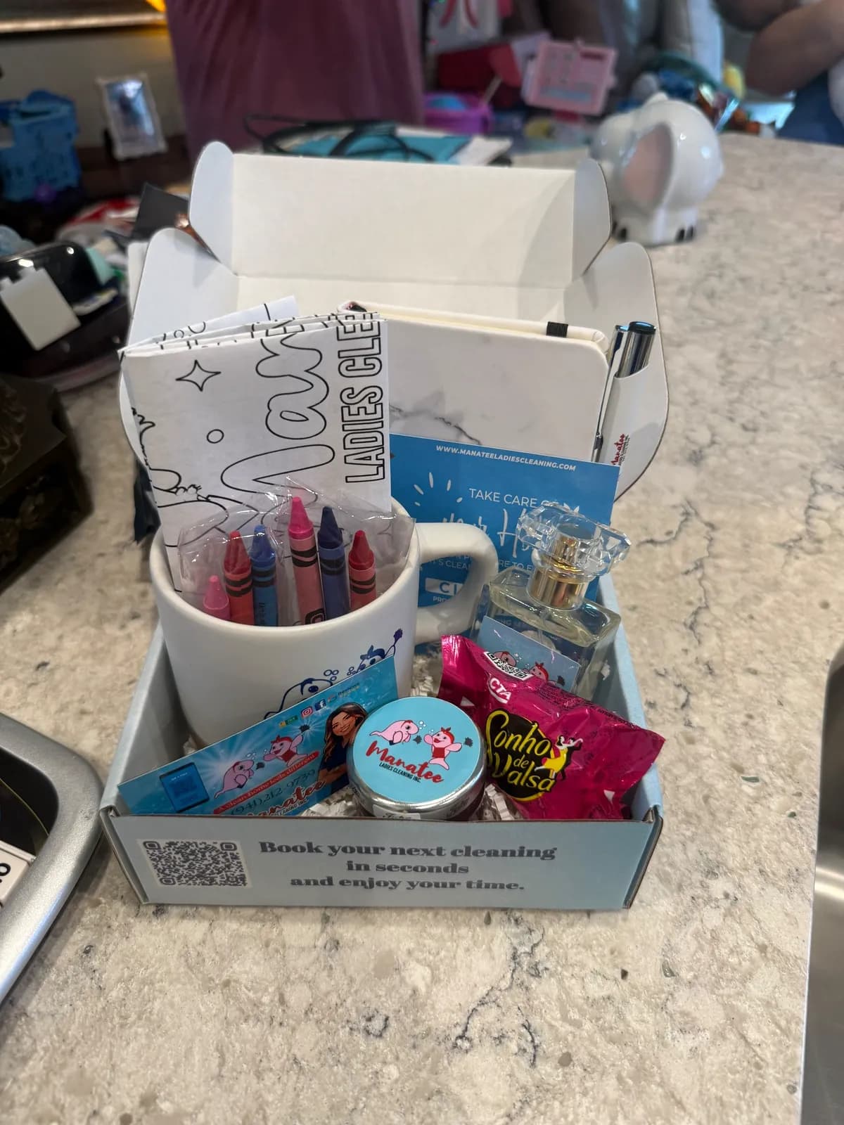The Manatee Ladies Cleaning welcome kit left for a new client, with branded mug and note