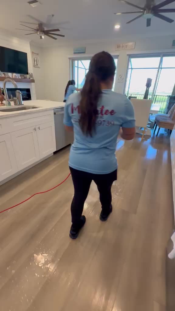 Manatee Ladies team restoring a hardwood floor with professional equipment